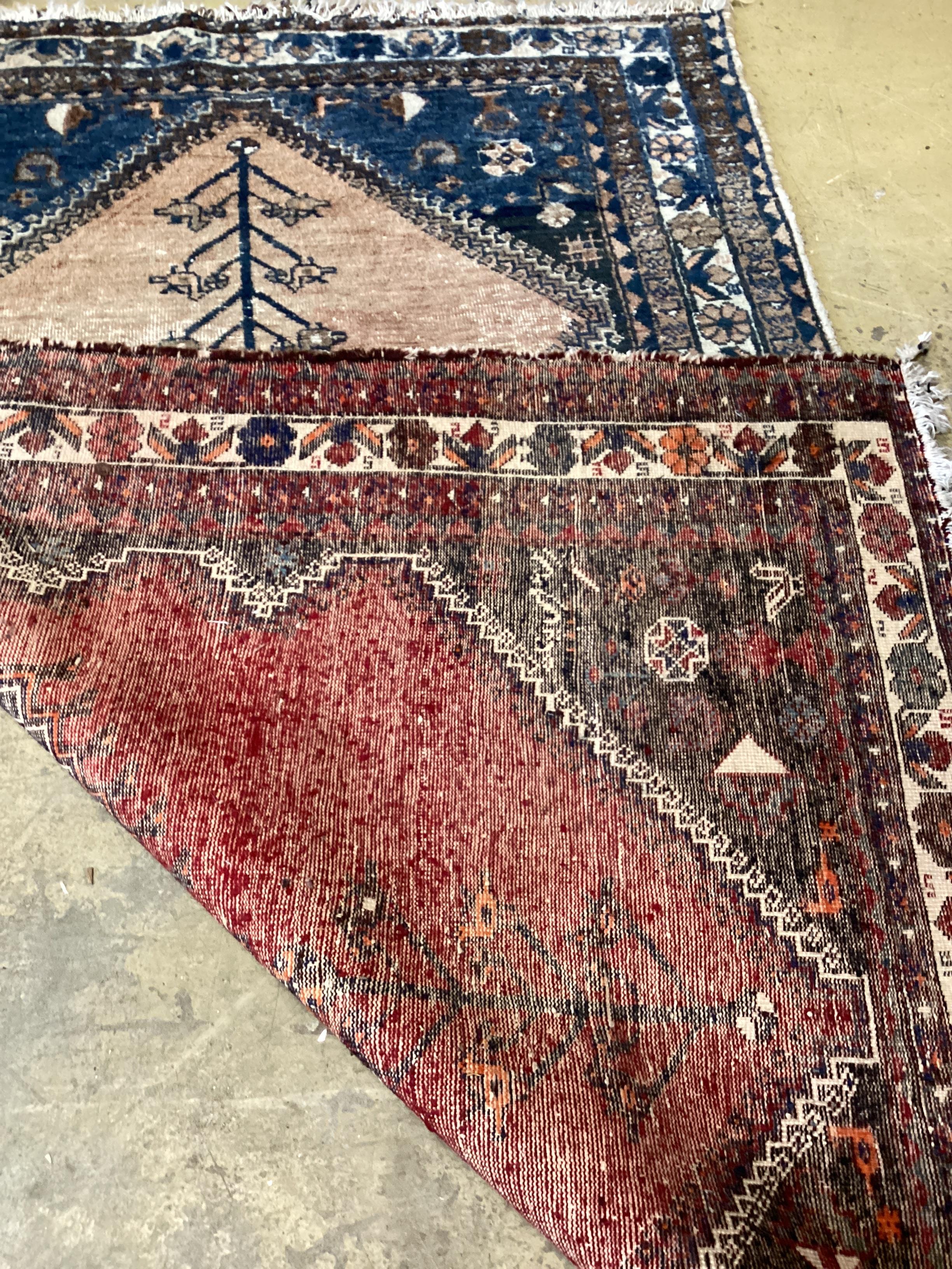 A Caucasian red ground rug, 194 x 136cm